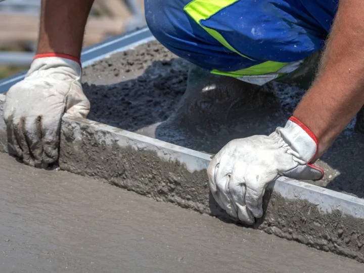 Concrete finisher screeding a fresh slab on a Toronto jobsite