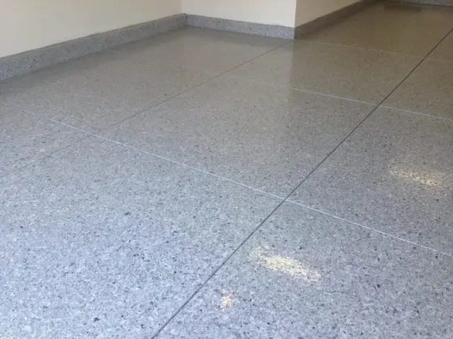 Broadcast-flake epoxy coating on a garage floor with a car parked on it