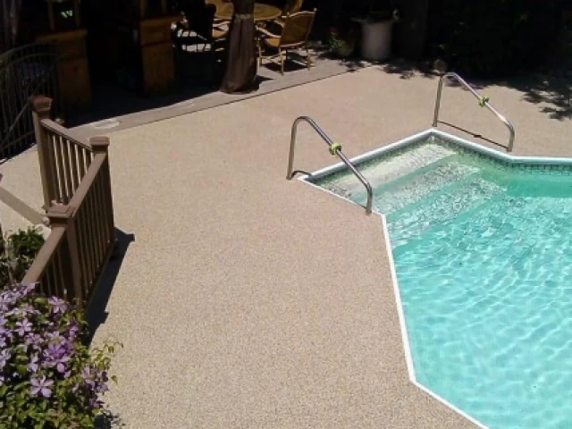 Resurfaced concrete pool deck with a slip-resistant flake finish
