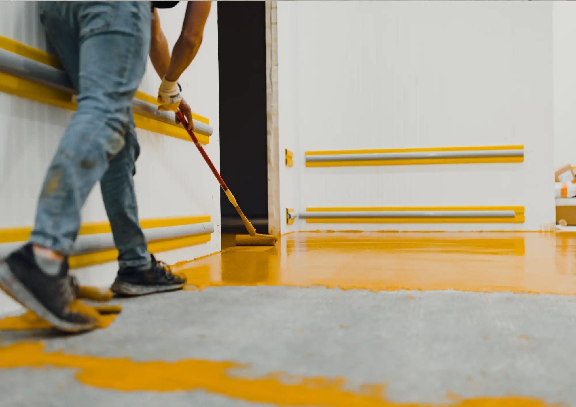 Concrete paint - man painting floor